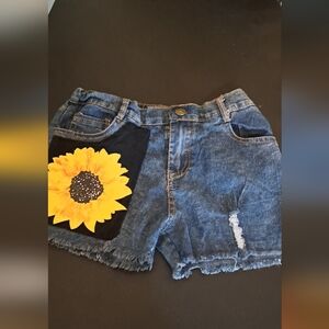 Girl's distressed shorts accented with a cute sun flower Good preloved condition
